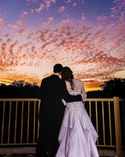 Rear view of silhouette couple looking at sunset