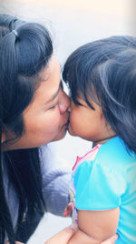 Mother and daughter daughter embracing outdoors