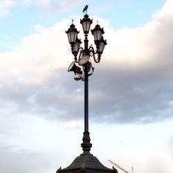 Low angle view of street light against cloudy sky