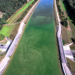 High angle view of river amidst trees against sky