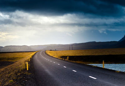 Road amidst landscape against sky in iceland