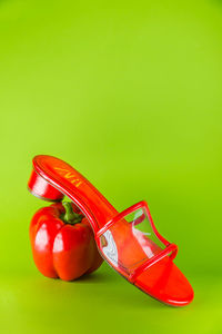 Close-up of red shoes over green background