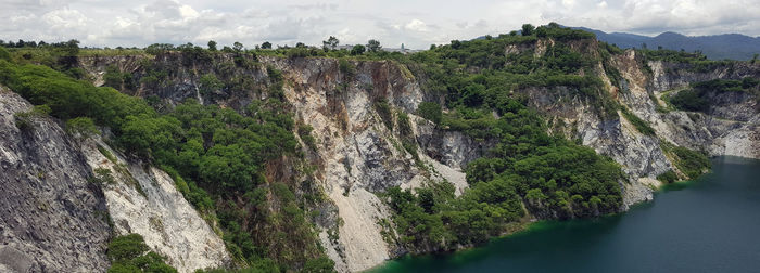 Panoramic view of river amidst mountains against sky