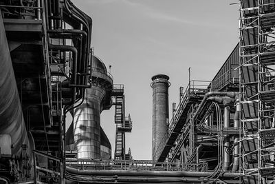 Low angle view of factory against sky