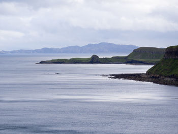 Scenic view of sea and mountains against sky