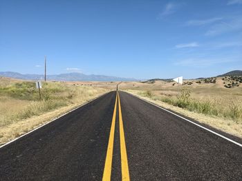 Road passing through landscape against sky