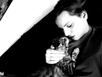 Close-up of young woman holding cat