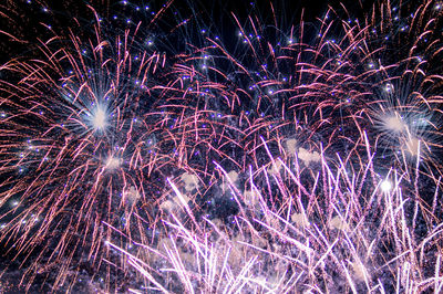 Low angle view of firework display at night