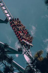 Low angle view of people in rollercoaster
