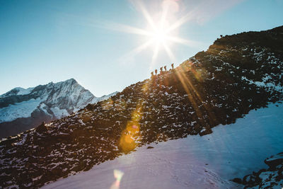 Sun shining over mountains during winter