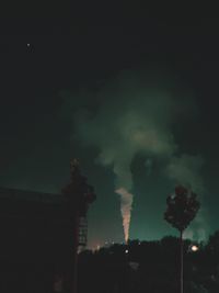 Low angle view of smoke emitting from chimney against sky