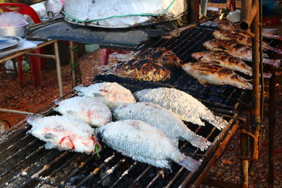 High angle view of fish on barbecue grill