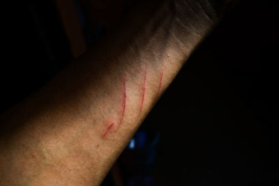 Close-up of human hand against black background