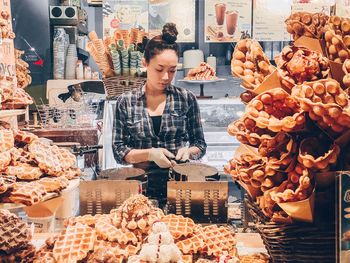 Woman standing in market for sale in store