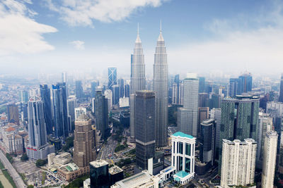 Aerial view of modern buildings in city against sky