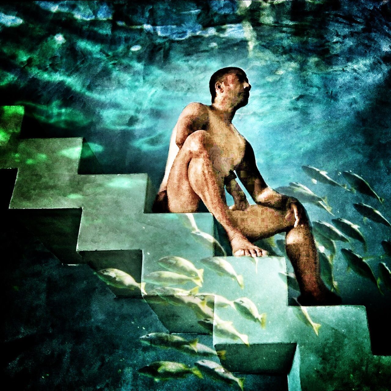 HIGH ANGLE VIEW OF MAN SITTING IN SWIMMING POOL