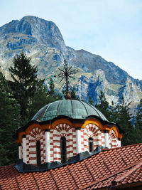 Exterior of building by mountains against sky
