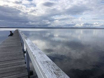 Pier over lake against sky