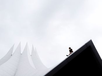 Low angle view of people against sky