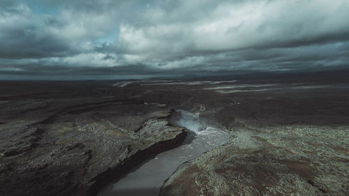 Scenic view of sea against storm clouds
