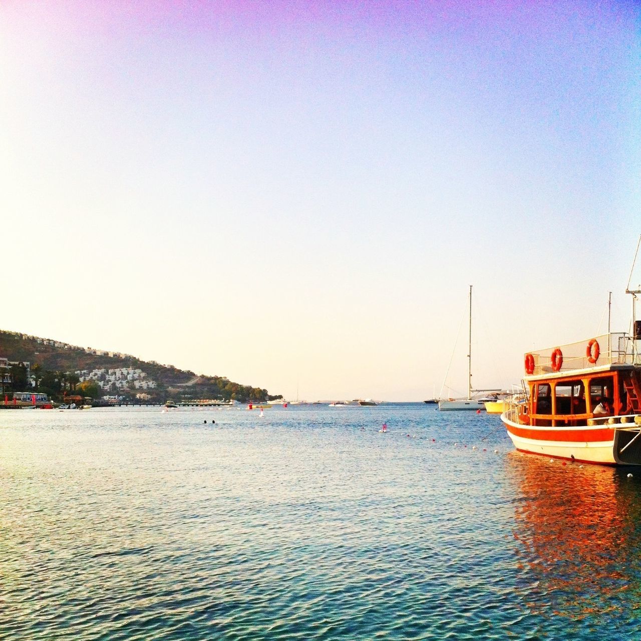 transportation, nautical vessel, mode of transport, water, boat, clear sky, copy space, waterfront, moored, sea, nature, travel, sailing, built structure, beauty in nature, tranquility, tranquil scene, outdoors, scenics, building exterior