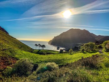 Scenic view of sea against bright sun