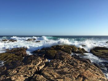 Scenic view of sea against clear blue sky