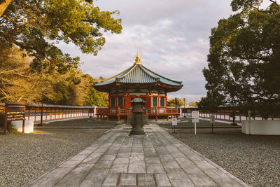 Gazebo by trees against sky