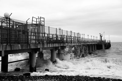 View of bridge on calm beach