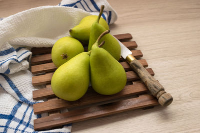 Fresh organic pears on a wooden table and knife