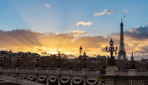 Buildings in city against cloudy sky