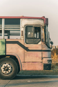 Old rusty car against sky