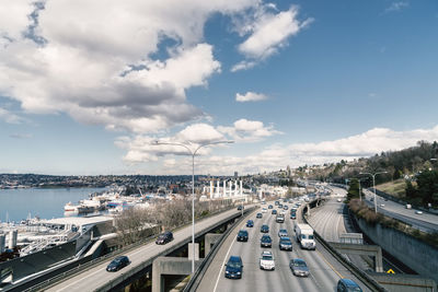 High angle view of cars moving on bridge against blue sky