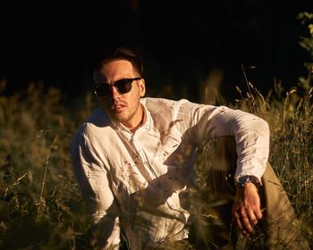 Young man wearing sunglasses on field