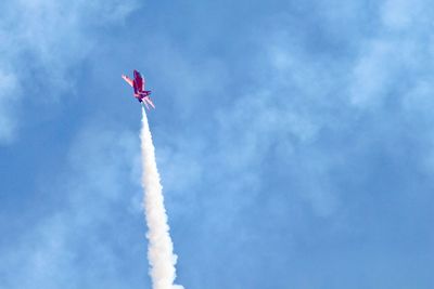 Low angle view of airshow against sky