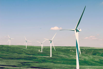 Windmill on field against sky