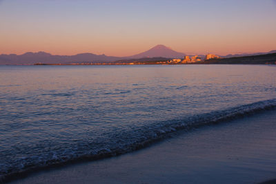 Scenic view of sea against clear sky during sunset