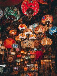 Low angle view of illuminated lanterns hanging in store