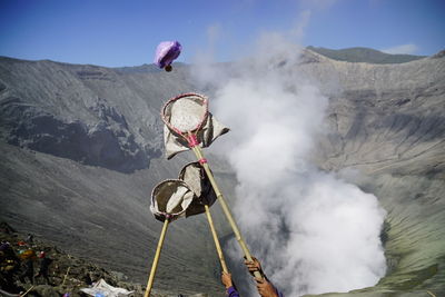 Offering falling in bird catching net during kasada festival at mt bromo