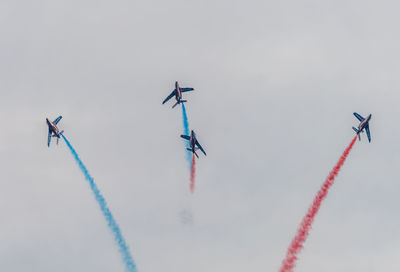 Low angle view of airplane flying against sky