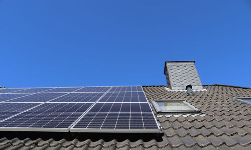 Solar panels producing clean energy on a roof of a residential house