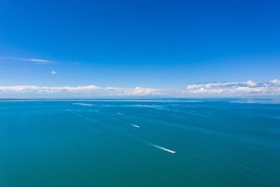 Scenic view of sea against blue sky