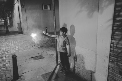 Man standing on street at night