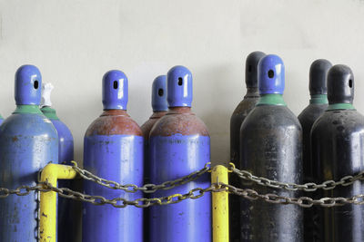 Close-up of bottles against blue wall