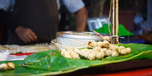 Man preparing food in market stall