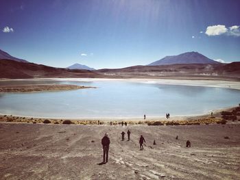 Scenic view of lake by mountains against sky