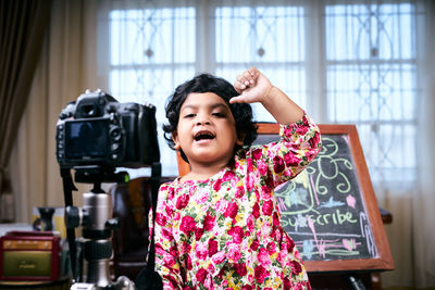 Portrait of smiling girl standing at home