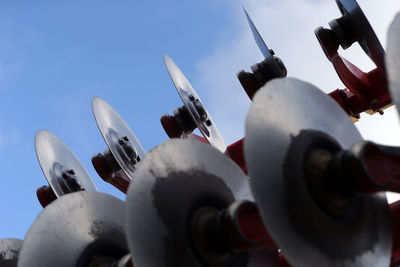 Low angle view of machinery against sky