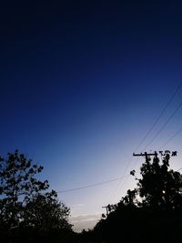 Silhouette trees against sky at night