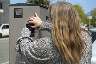 Rear view of woman using mobile phone